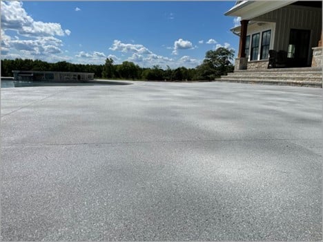 aggrekoat decorative concrete overlay on a large driveway that is the look of gray textured stone 