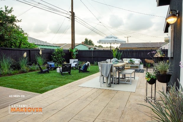 a backyard patio in a suburban neighborhood with resurfaced concrete this project was done as part of extreme home makeover 