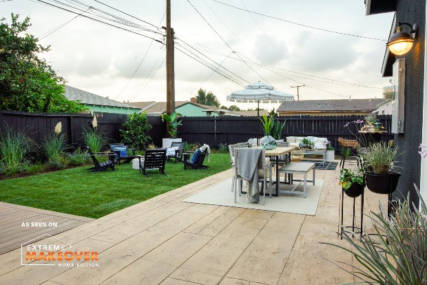 a backyard patio in a suburban neighborhood with resurfaced concrete this project was done as part of extreme home makeover 