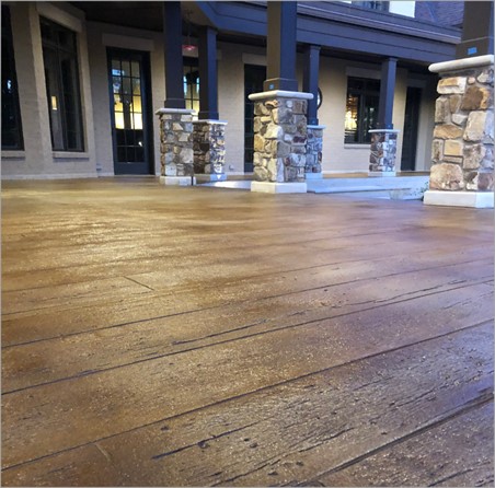 close up of wood grain in the concrete overlay on a patio 