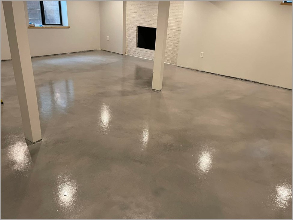 Light brown stained concrete floor inside a home basement 