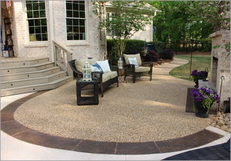 A textured and stained darker stamped concrete border defines this gorgeous outdoor room