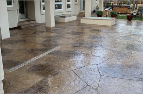 decorative concrete overlay on a back patio that looks like stone