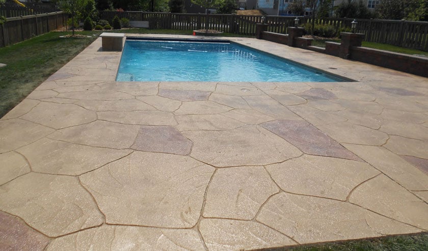 Decorative stamped resurfaced in western brown highlights pool deck